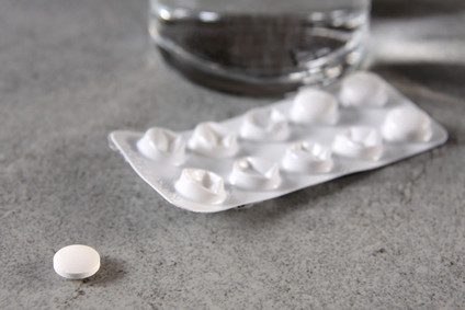 Nebenwirkungen von Tabletten gegen Seekrankheit: Wasserglas & Blisterverpackung